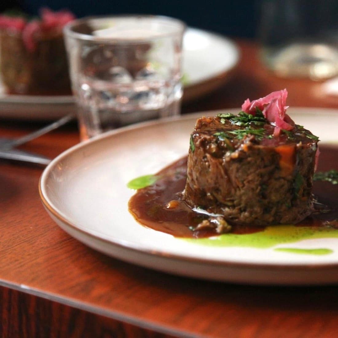 Joue de bœuf braisée pressée, nappée d’une sauce au jus avec huile d’herbes, chez Ty Louis